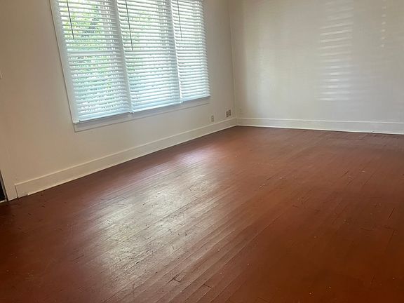 Large living area with hardwood floors.