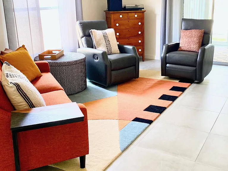 Living room with nice couch and 2 leather recliners.