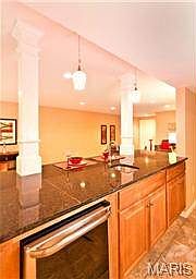 Granite wet bar with beverage fridge.