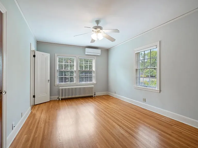 Master bedroom with mini-split AC unit.