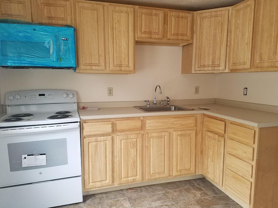 This is the kitchen with newer cabinets,stove and kitchen counter