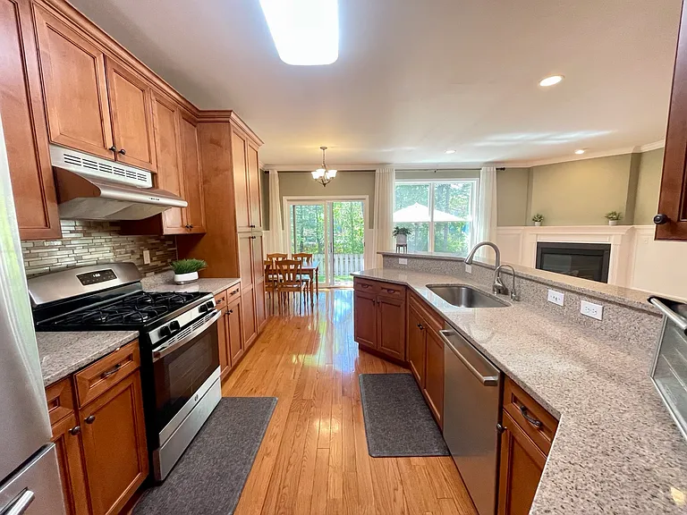 Updated kitchen with granite counters, ample storage, and natural light