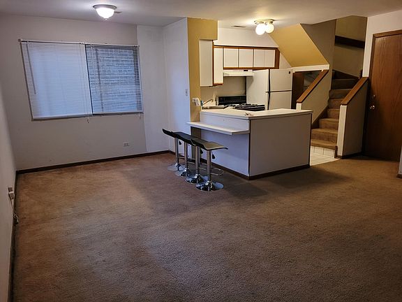 Dining Area, Kitchen, and Stairs to the Second Floor, from Living Area