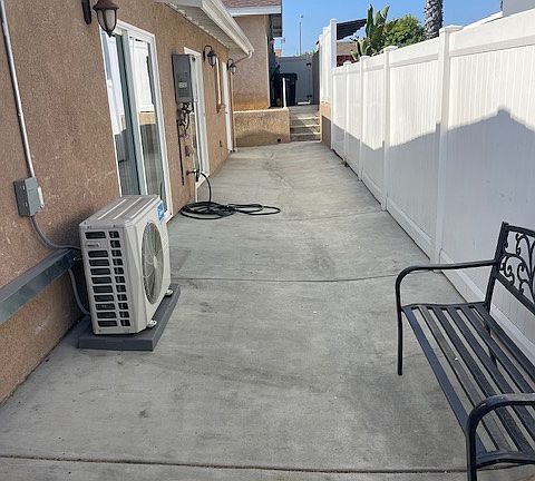 side patio with entrance to kitchen and separate entrance to primary room