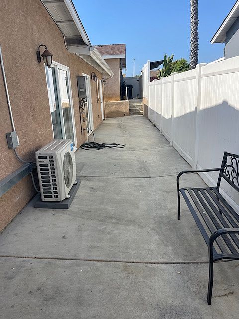 side patio with entrance to kitchen and separate entrance to primary room