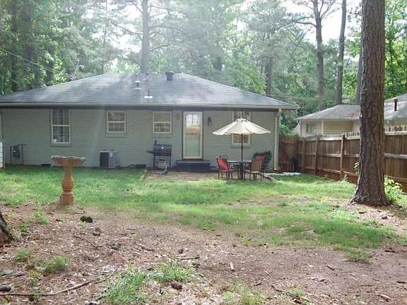 Rear private fenced in yard with shed