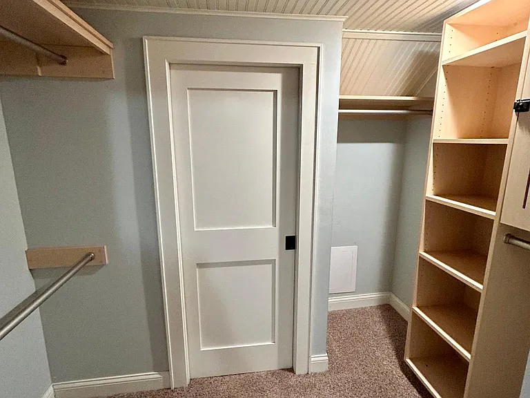 Walk-in closet with pocket doors connect to room and bathroom/laundry.
