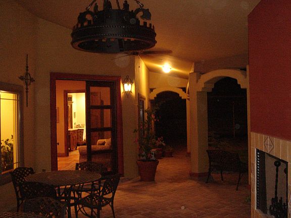 covered back porch, fireplace, and master entrance
