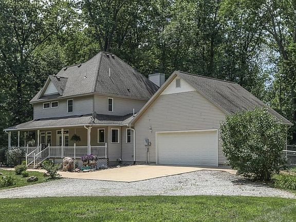 Property is accessed via a long driveway that winds its way to a dramatic reveal of this house atop the hill.