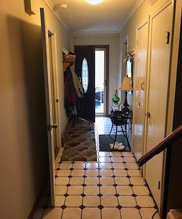 Tiled entry with Master Bedroom to right, half bath, closets.