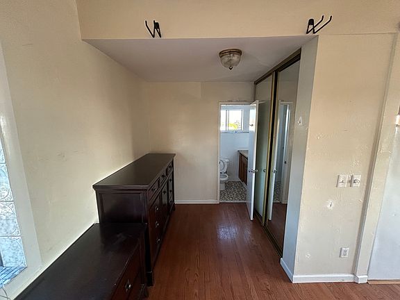 Dressing area or small office. Second large closet with mirrors. The two chest of drawers can stay or be removed