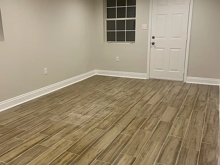 Spacious guest bedroom with a closet and convenient outdoor access to the carport area.