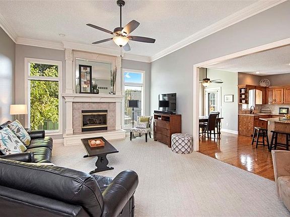 Great room with 11' ceilings, fireplace and a great neutral color scheme.