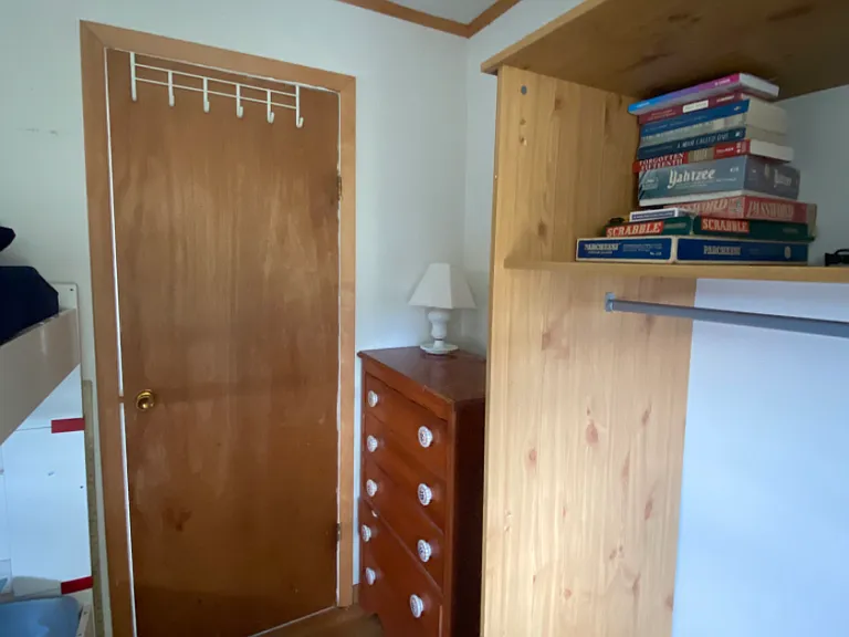 Other view of bedroom#2 :beds on left , armoire and dresser on right, door in center