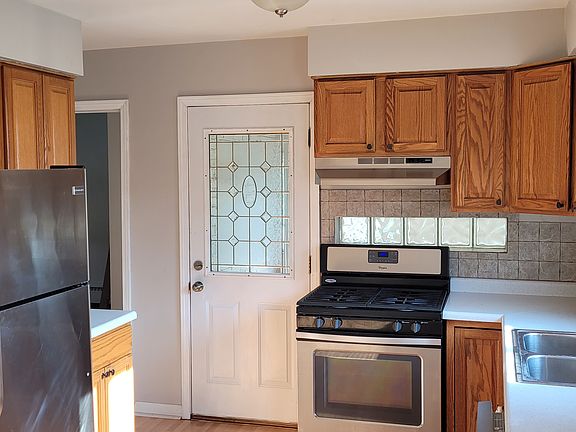 This eat-in kitchen includes stainless steel appliances and a dishwasher.