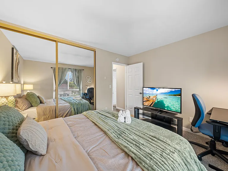 A king bed, convenient workspace, and plenty of closet space await you in this comfortable bedroom.
