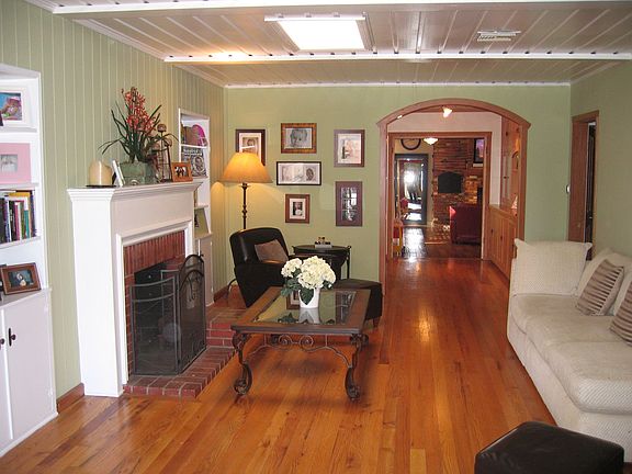 The living room offers a serene & warm environment w/the charming period f/p
