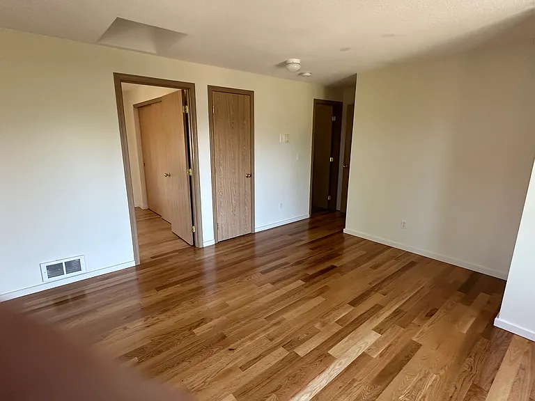 Upstairs great room - showing doors to (Master) bedroom, linen closet and upstairs bathroom.