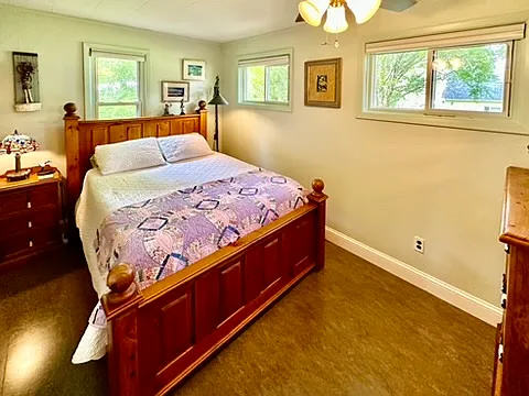 This queen bedroom has natural lighting from 3 windows making it airy and light.