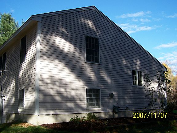 Exterior of unit showing side yard and rear of the unit. Older picture I had without snow

Side view of duplex