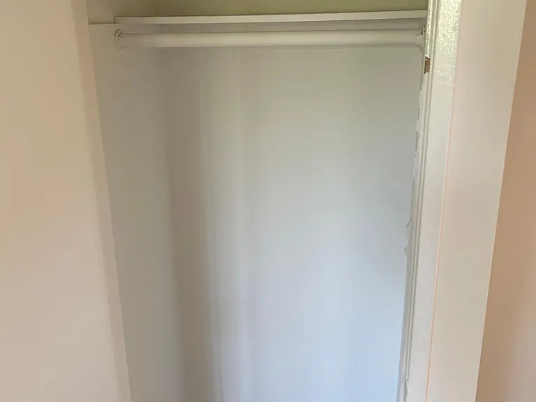 Entry closet nextn to a indented area that is perfect for a bookcase or small desk