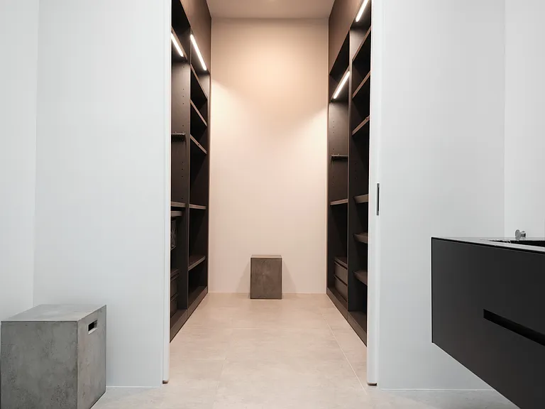 Walk-In Closet & Dressing Area _ Designed for the fashion-forward resident, this walk-in closet offers built-in shelving, soft-close drawers, and elegant lighting, making every wardrobe selection feel like an experience.