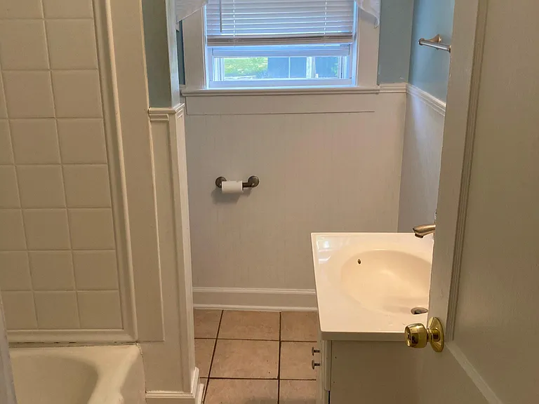 Bathroom with tiled floor.