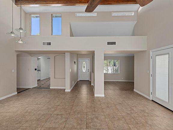 Living room, open den, and kitchen.
