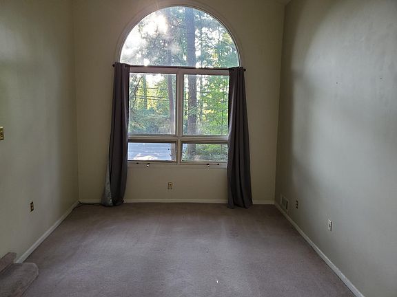Den with large picture window.