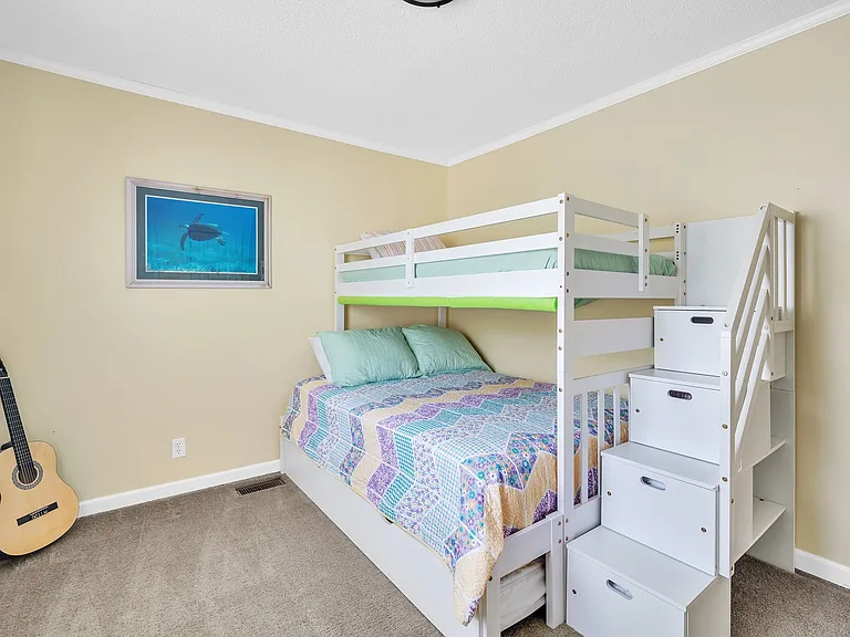 Bunk bed room with a full size bottom bunk, and a twin size top bunk. Another trundle bed pulls out from underneath. Sleeps 4. And the steps are drawers for clothes.