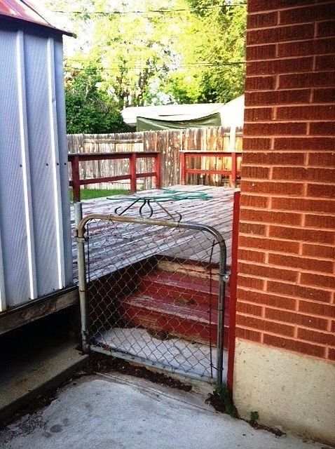 Gate from carport to deck in back & back door to unit