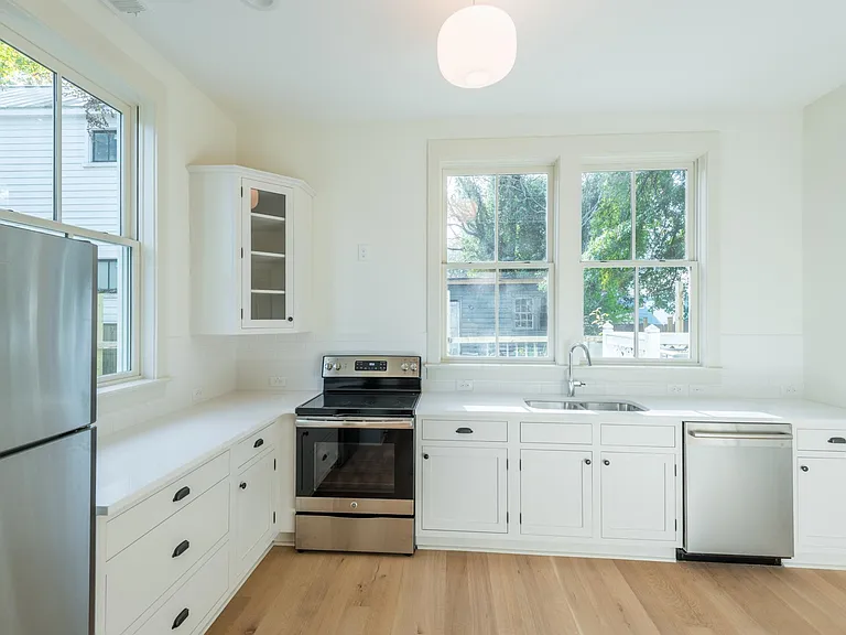 The kitchen has incredible natural lighting and looks out to the outdoor deck area. Stainless steel appliances and custom cabinetry are an added plus!