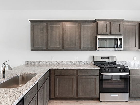 The kitchen has gorgeous wood cabinetry