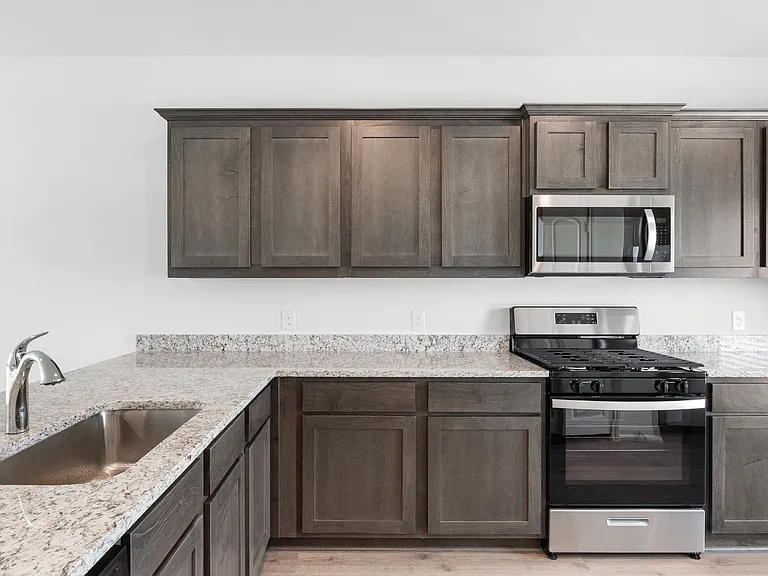 The kitchen has gorgeous wood cabinetry.