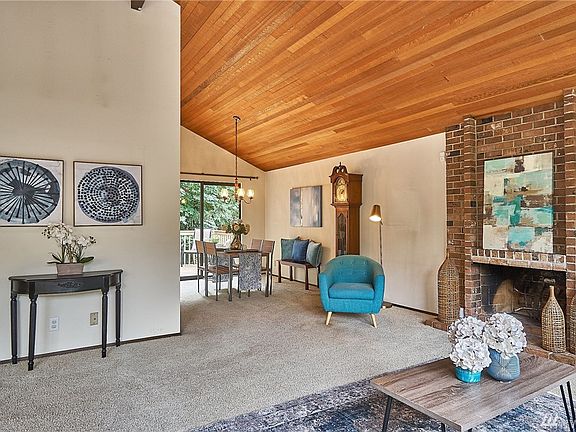 A tall brick fireplace adds charm