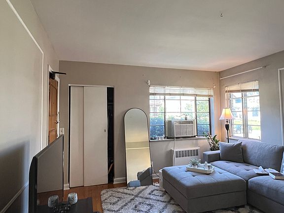 Large living room with tons of natural light and hardwood floors
