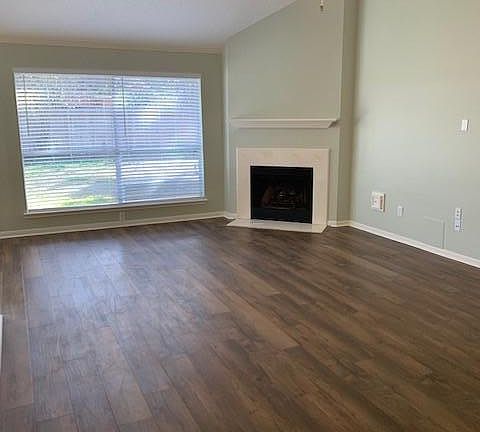 Family Room with gas fireplace, breakfast room to left.