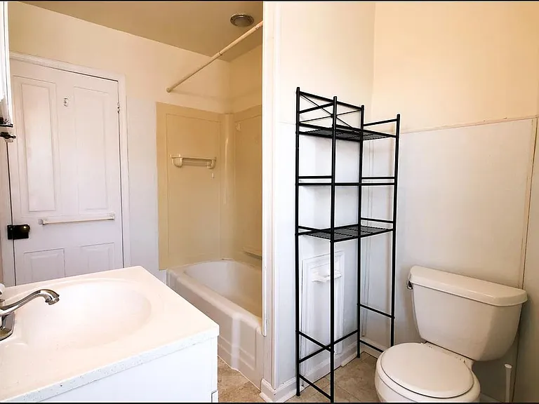 The bathroom has been refreshed with a tile shower, new floors, an upgraded vanity and mirror, and a new window to fill the space with natural light. Updated listing photos coming soon!