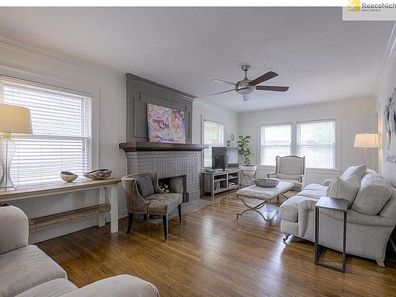 ENJOY GLEAMING HARDWOOD FLOORS IN A LIVING ROOM SURROUNDED WITH WINDOWS!