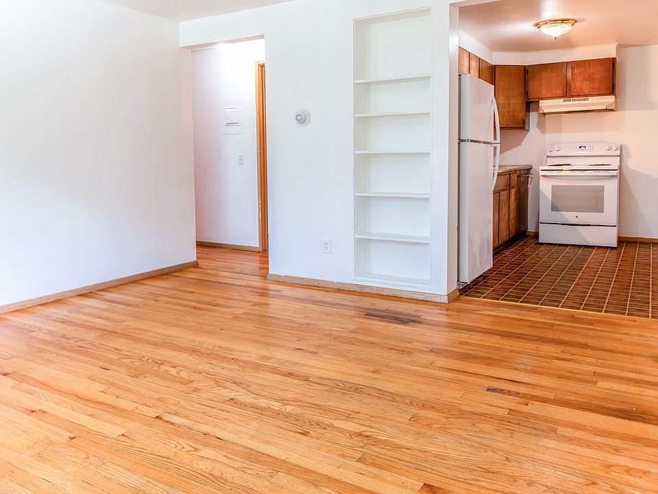 Kitchen and living room featuring built-in shelves