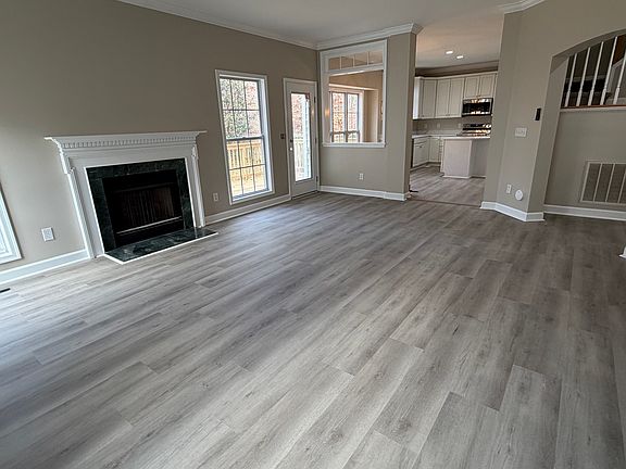 Living Room with gas log fireplace and open to the kitchen area. French door to the rear exits to the new deck