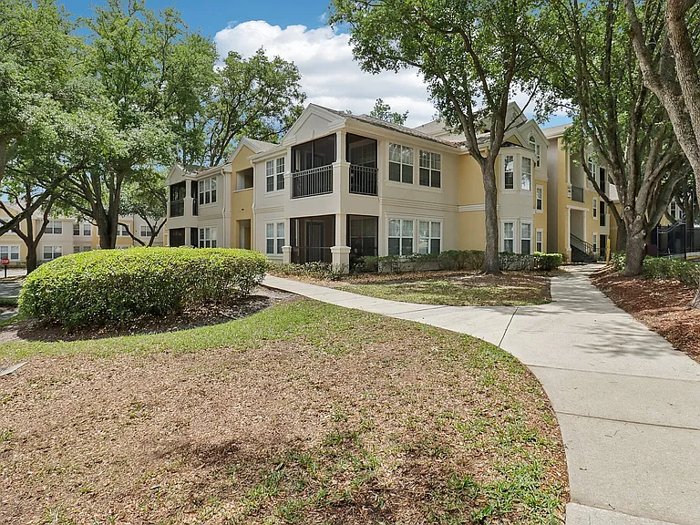 Comfortable apartment living with private balconies and shaded community walkways