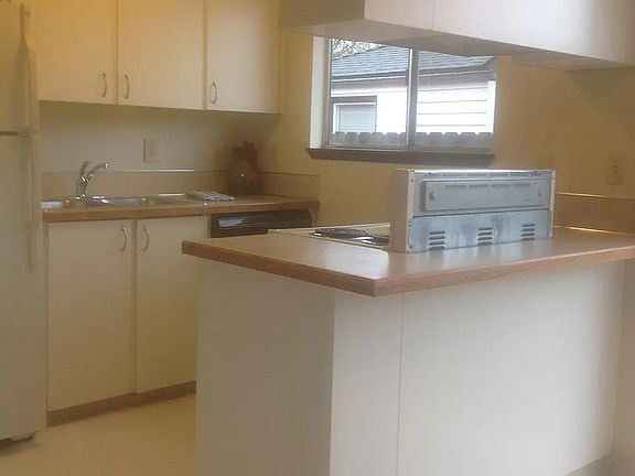 Stainless steel dishwasher added on the right side of the sink. Washer and Dryer on the left of the kitchen with pantry.