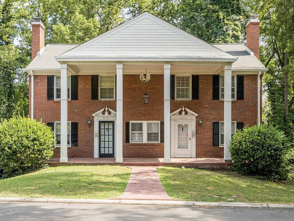 Exterior of home. Rental on right side with white door.
