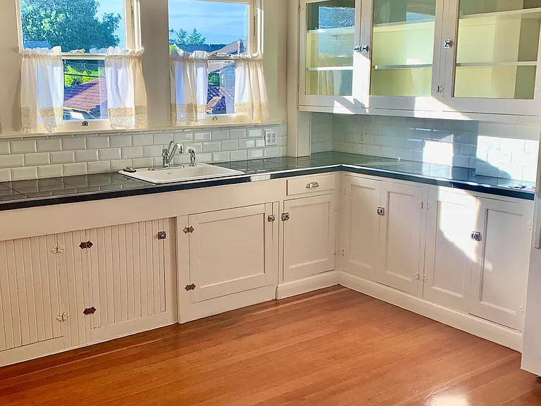 Original 1923 kitchen with new granite counter top and restored cabinets. New copper plumbing.
