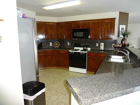 Kitchen w/granite counters and a lot of counter space. Huge breakfast bar.