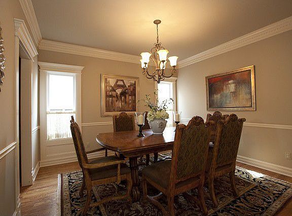 Formal dining withhardwoods and crown molding.