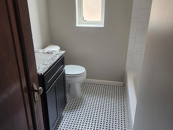 Fully redone bathroom with subway tile and granite vanity top