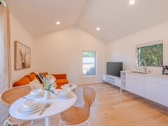 Kitchen and living area, with high cathedral ceiling and lots of natural light.