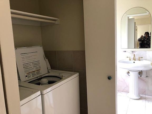 Washer/dryer next to 1/4 bath.